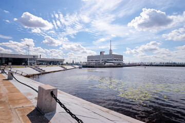 Fototapeta premium Urban Waterfront With Modern Building Under Bright Blue Sky..