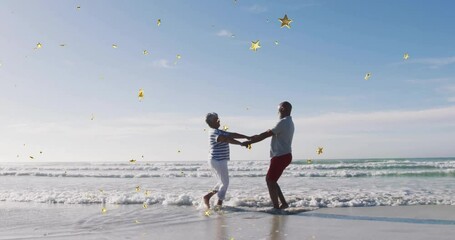 man and woman dancing on sandy shore with gentle waves, animated heart icon showing health metrics - Powered by Adobe