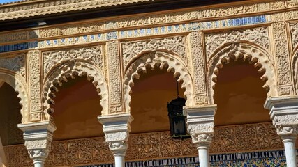 ornate arches in Seville, Spain with intricate carvings, columns, and an antique lantern