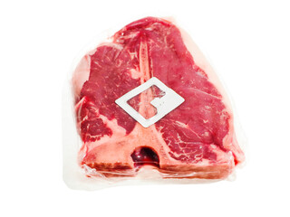 Expensive T bone steak in vacuum packaging and with security electric tag on white background....