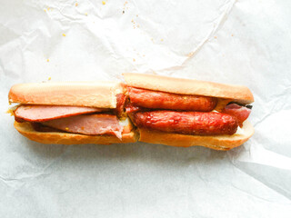 Traditional tasty Irish breakfast roll with white bread, sausage, bacon or rasher, fried egg and...