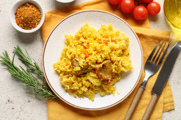 Plate of tasty pilaf with cherry tomatoes and spices on white background