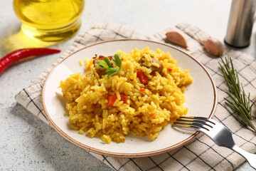 Plate of tasty pilaf with chili pepper, rosemary and garlic on white background, closeup