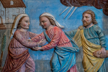 Naklejka premium Wood bas relief (19th century) of Visitation of the Virgin Mary to her pregnant cousin Elizabeth.
