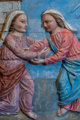 Wood bas relief (19th century) of Visitation of the Virgin Mary to her pregnant cousin Elizabeth.