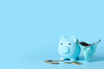 Piggy bank with coins and wallet on blue background