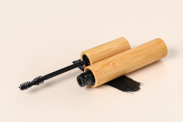Naklejka premium Black mascara with smear on beige background