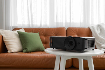 Black projector on table in room, closeup