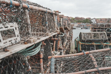 Lobster pots being stored at a seaside harbour