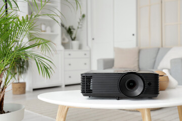 Black projector on table in room, closeup