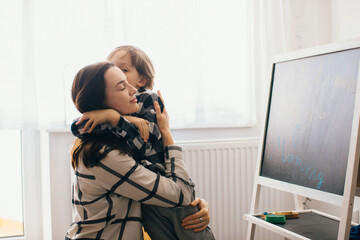 Mother and son sharing a tender hug at home