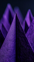 Close-up of deep purple textured paper folded into sharp peaks, creating a geometric, abstract image, showcasing a sense of depth and mystery, ideal for design backgrounds