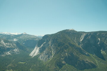 Yosemite National Park in California’s Sierra Nevada mountains green foliage on sunny day beautiful landscape