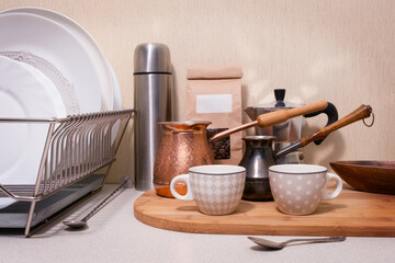 A kitchen counter with a wooden board and a silver dish rack