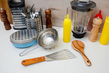 A kitchen counter with various utensils and kitchen tools