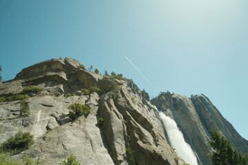 Yosemite National Park in California’s Sierra Nevada mountains aesthetic greenery landscape scenery on sunny day granite cliffs waterfall