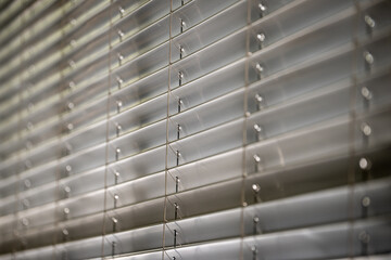 Workshop and office metal horizontal blinds line detail on background.	