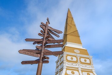 Historical Obelisco del Alto de la Memoria with directional distance markers showing connections to other locations in Angra do Heroismo, Terceira, Azores archipelago.