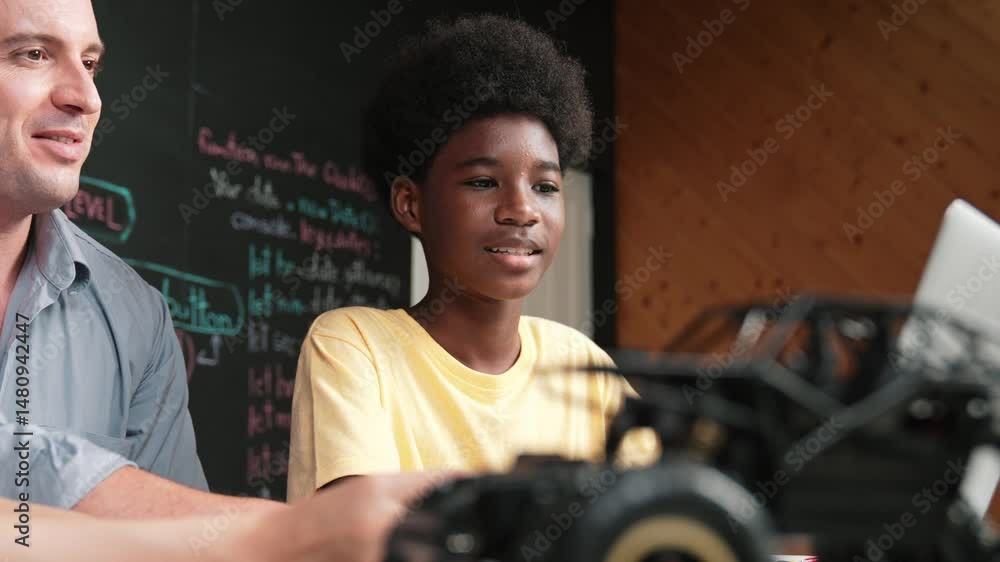 Aufkleber african boy using laptop to program code or prompt with car model placed while teacher and caucasian