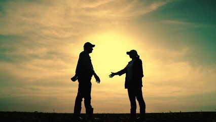 Fototapeta premium Farmers Businessmen shaking hands sunset outdoor, silhouette man woman. Handshake signing contract. Concept teamwork business. Business owners conclude contract. Cooperation, partnership in business