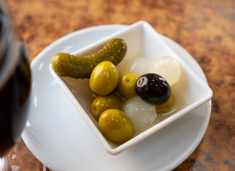 Black and green olives, onion, pickled cucumber - delicious snack