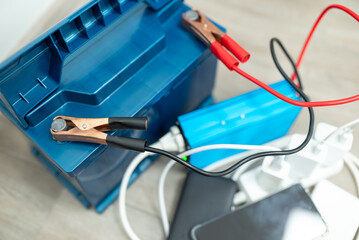 Inverter connected to car battery charging phones. Inverter and phones connected to car battery on...