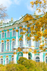 the incredibly picturesque facade of the Winter Palace through the branches of trees on a clear...