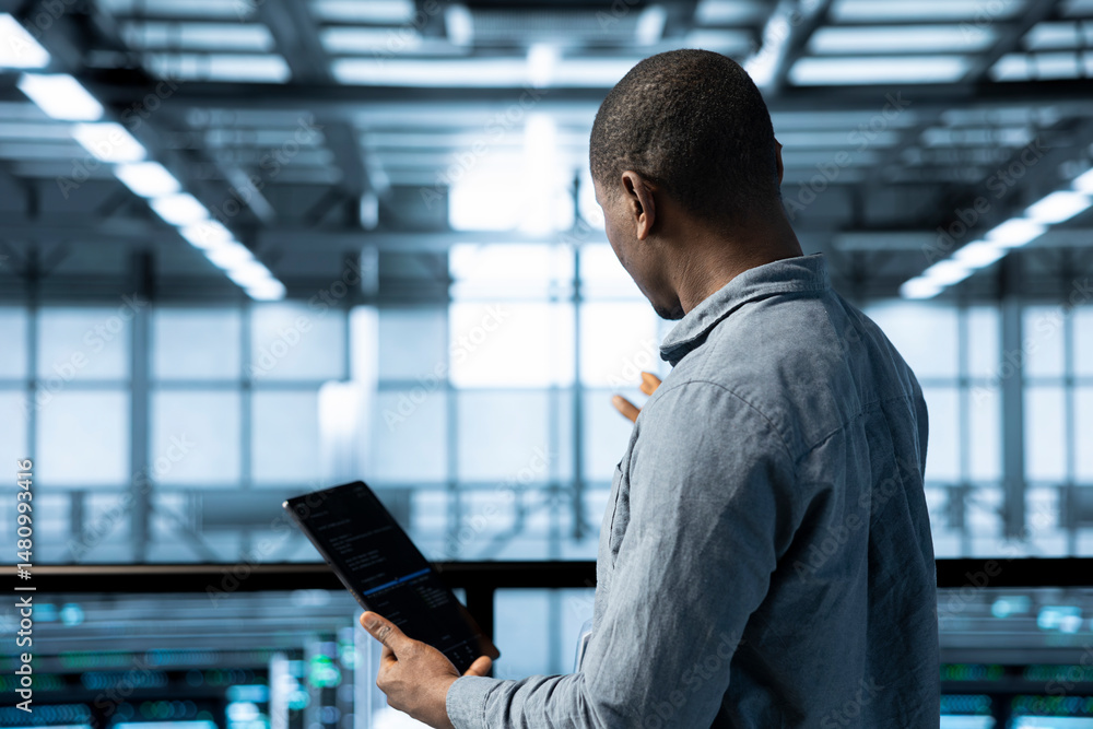 Poster technician in data center using tablet adjusting power management settings, verifying compliance req