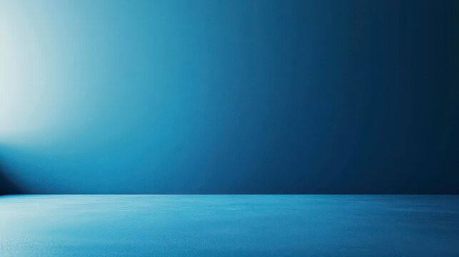 Simple blue studio background with gradient wall and floor.