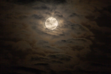 Fototapeta premium Full moon in the dark night sky with clouds, 