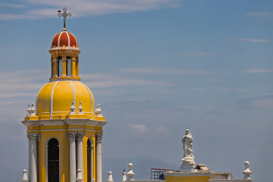 Close-up of tower with cross and figure of the Virgin Mary in the cathedral of Chiclayo, Peru