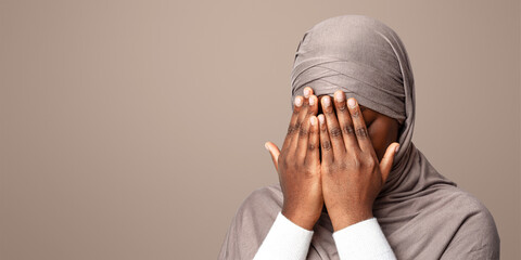 Closeup Shot Of Black Muslim Woman In Hijab Covering Face With Hands, Crying African Islamic Lady...