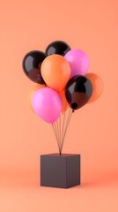 Glossy Pink Black Orange Balloons Floating Above Dark Gift Box on Peach Background