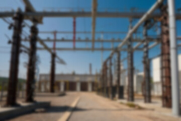 blurry electrical substation, large transformer as voltage regulator, there are many high voltage electrical panels