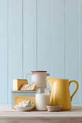 cozy arrangement of diverse cheeses buttermilk and milk on wooden table