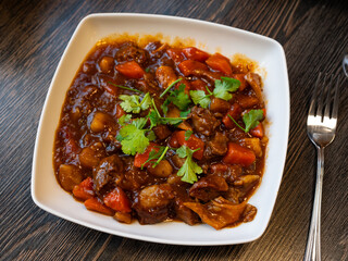 Appetizing chinese dish beef stew served with parsley on plate