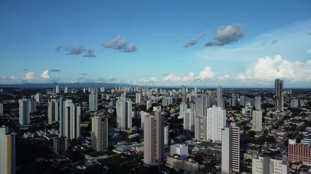 Aerial view of Cuiaba, Brazil, featuring modern cityscape amid lush green vegetation and forest
