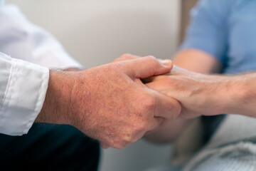 Obraz premium Doctor holding hands and comfort male patient. Medical health care, disease diagnosis and empathy communication support. Healthcare therapy, psychotherapy, wellness consultation in hospital clinic.