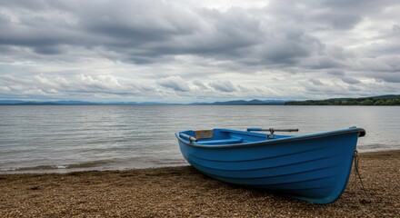 Naklejka premium Blue boat on shore reflecting tranquility and escape, with overcast sky and calm water