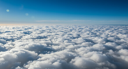 Naklejka premium Aerial View of a Sea of Clouds Under a Clear Blue Sky