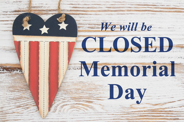 Fototapeta premium Closed Memorial Day sign with retro USA red, white and blue star and stripes heart on weathered wood