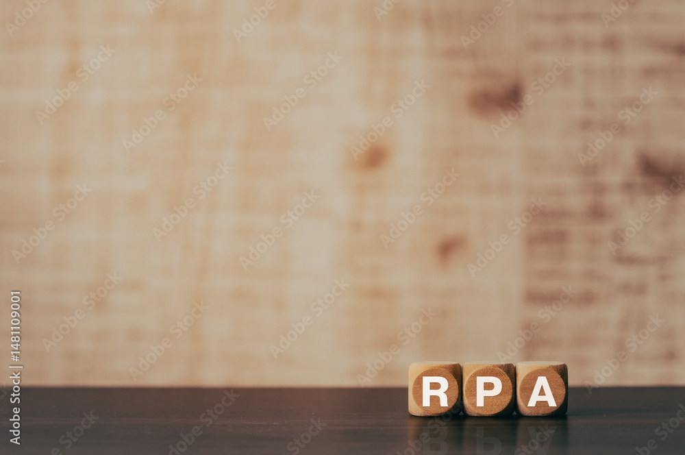 Poster there is wood cube with the word rpa. it is an abbreviation for robotic process automation as eye-ca