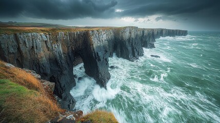 Dramatic coastal cliffs, archway, stormy sea