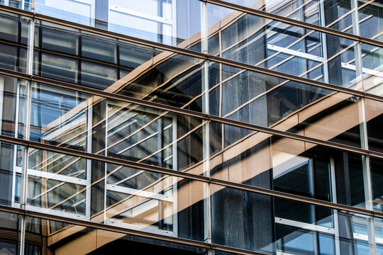 facade of modular housing units with visible scaffolding, highlighting structural repetition and modern building process in Copenhagen, real estate industry.