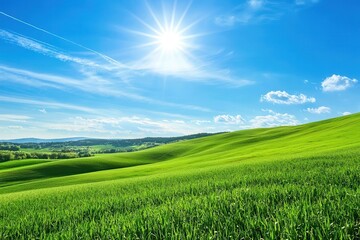 Fototapeta premium Lush Green Hills Under a Bright Sun with Clear Blue Sky and Wispy Clouds in Background