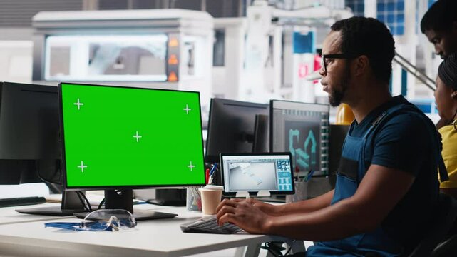 African american male engineer does troubleshooting on copy space display, fixing errors to ensure seamless solar panels manufacturing. Technician works in the assembly line Camera A