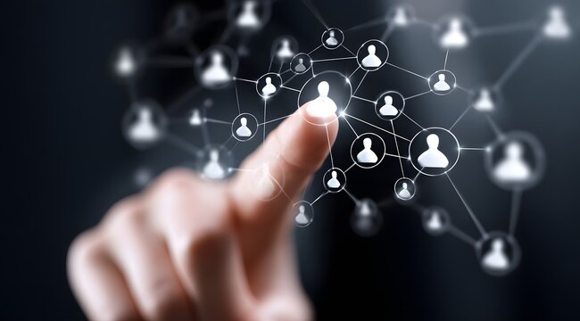 A hand pointing towards a digital network of interconnected user profiles symbolizing social media connections and online community engagement in the modern digital age - Powered by Adobe