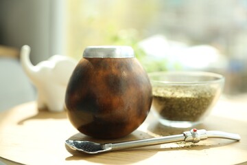 Traditional yerba mate tea on wooden table indoors, closeup