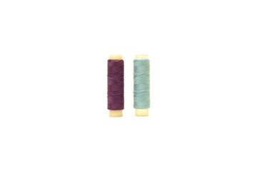 Purple spool and Tosca spool of sewing thread isolated on white background 