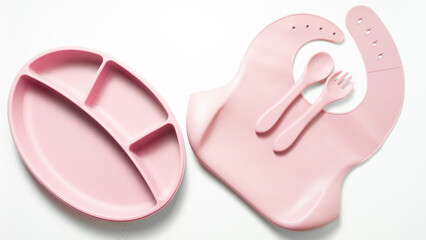 Cute baby feeding accessories in pink: divided plate, baby bib with pocket, and silicone spoon and...